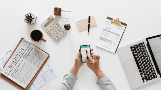 tools for a financial future: phone, laptop, clipboards