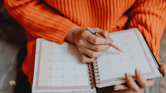 orange sweater girl with planner