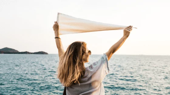 girl holding scarf in air