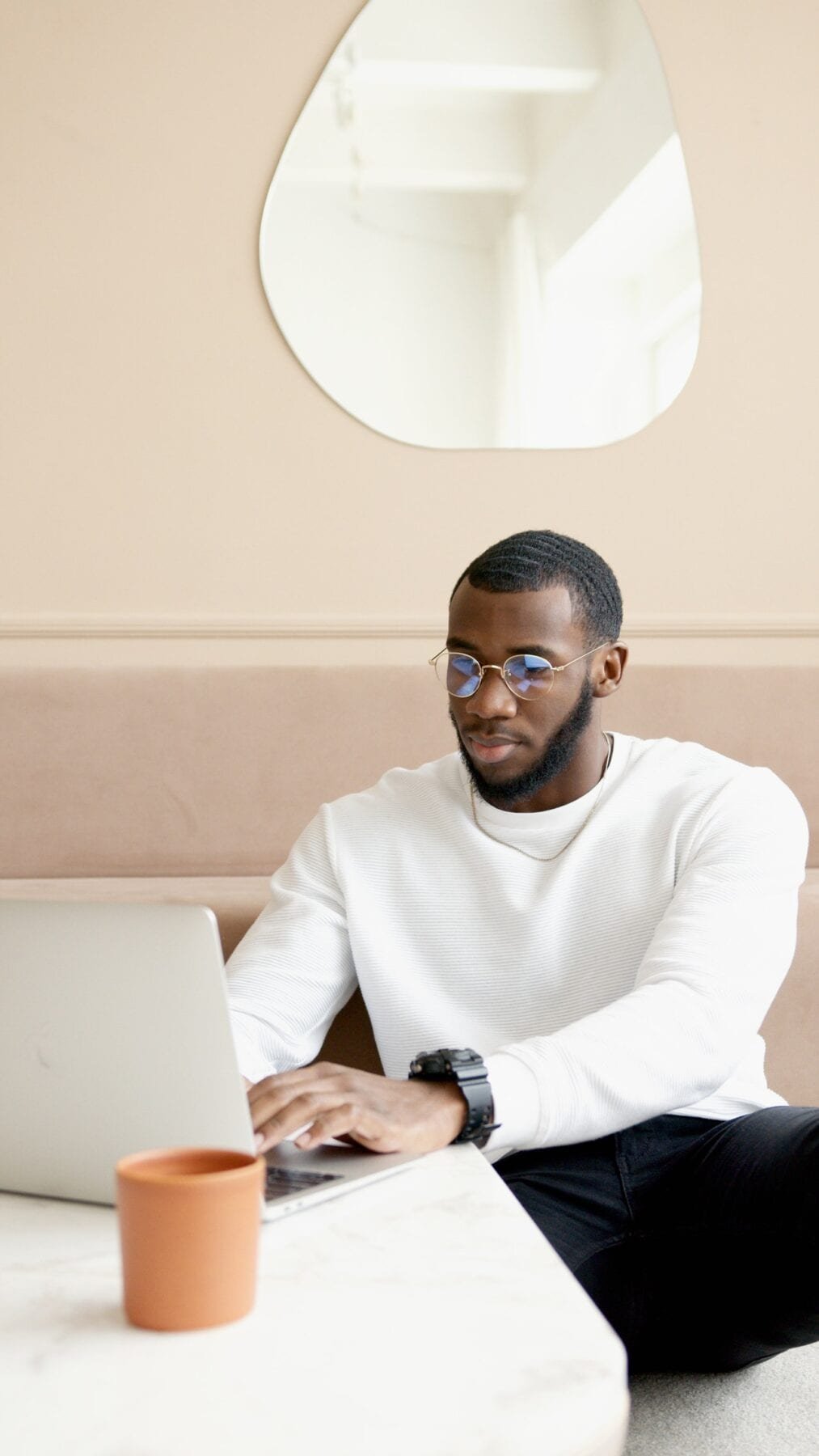 man typing on laptop