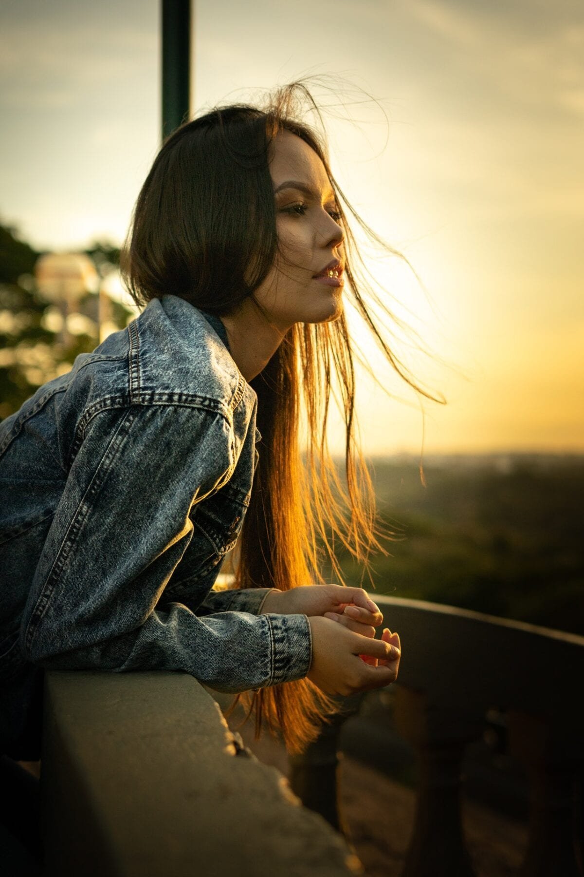 woman looking over a bridge