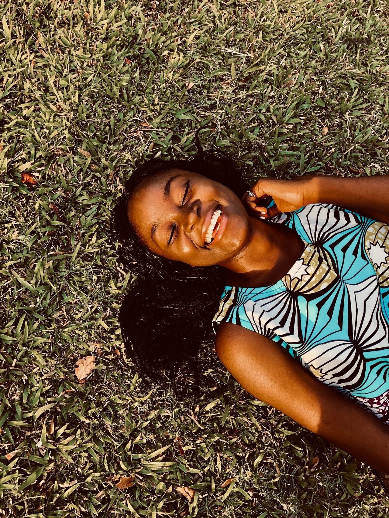 Woman Smiling Lying on Grass