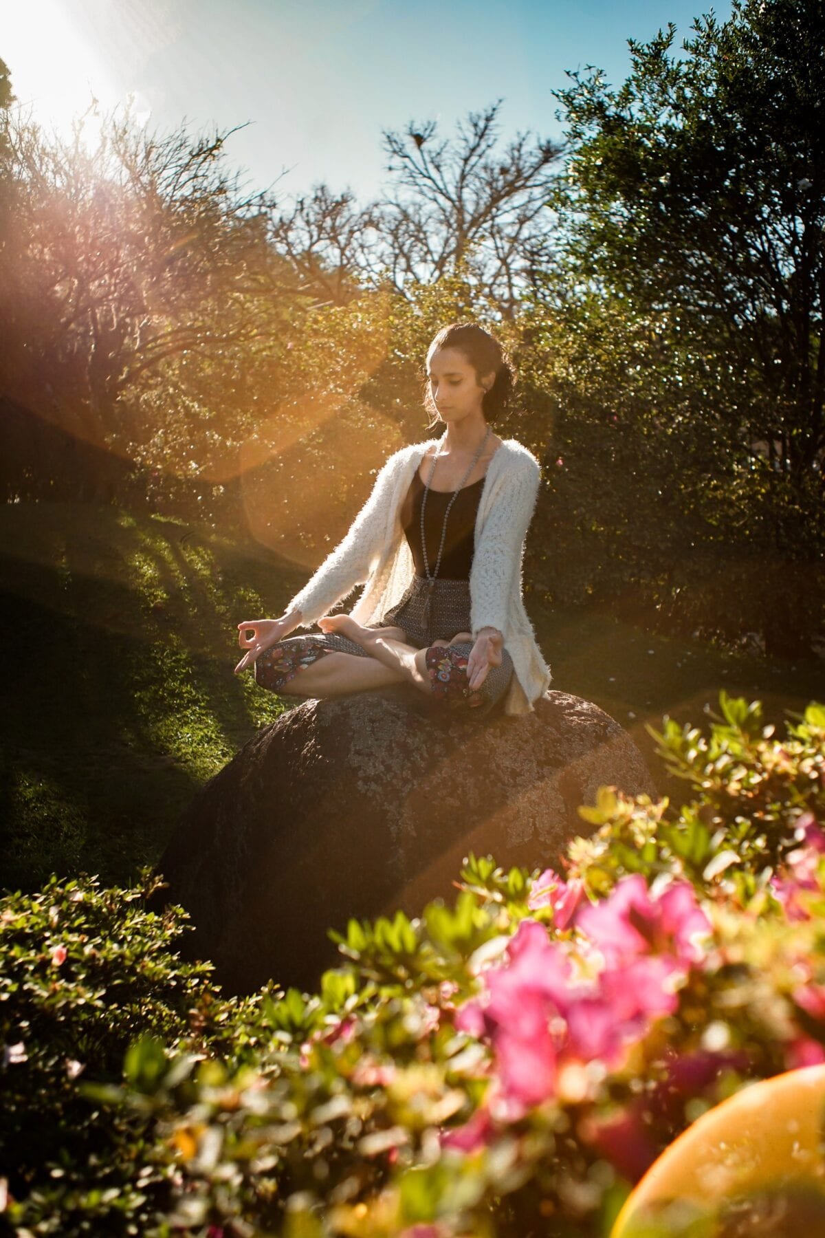 girl meditating on a rock
