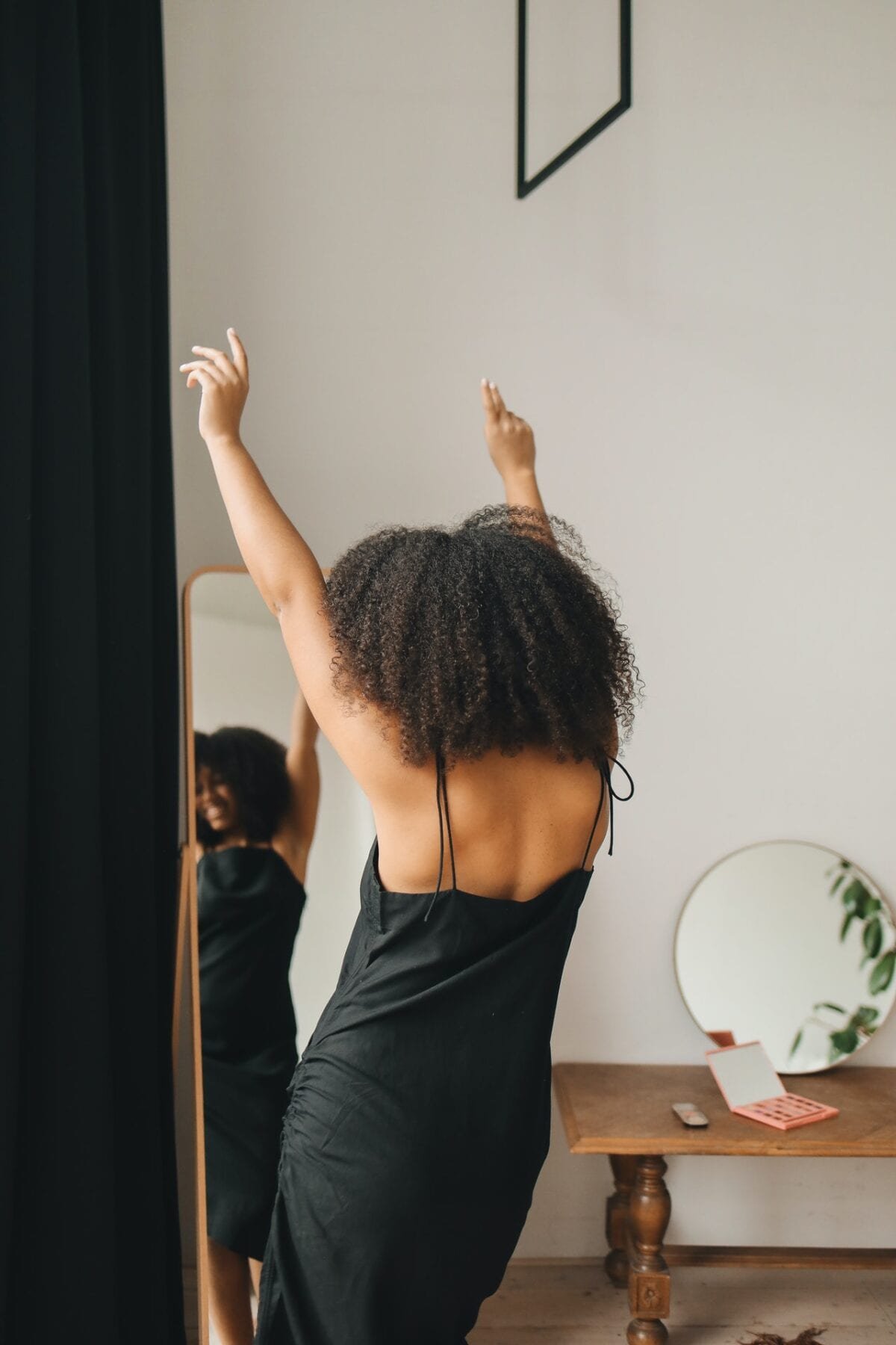 girl dancing in front of a mirror