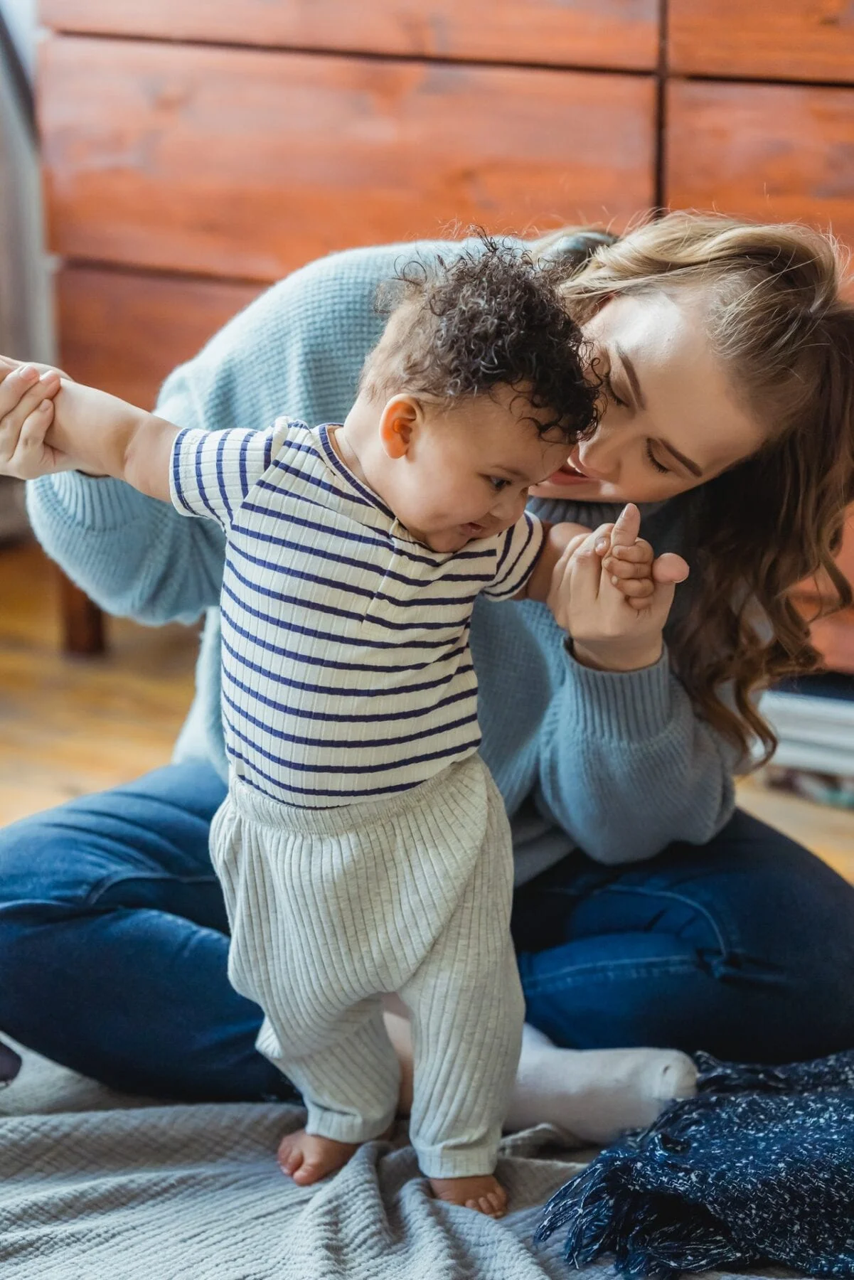 woman playing with baby
