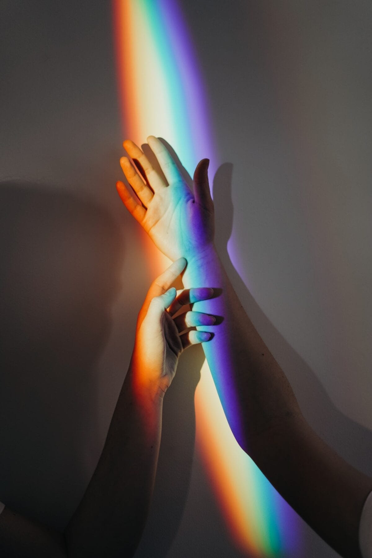 rainbow lgbtq light on two arms